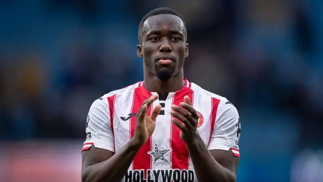 Michael Kayode applauds the Brentford fans