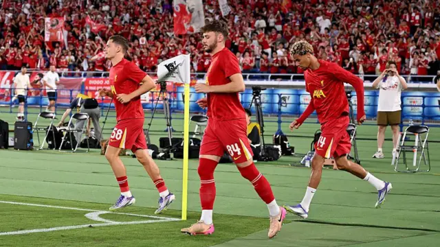 Florian Wirtz, Conor Bradley and Hugo Ekitike of Liverpool during the warm up before the MEIJI YASUDA J.LEAGUE World Challenge 2025 presented by The Nippon Foundation match between Yokohama F•Marinos and Liverpool at Nissan Stadium 