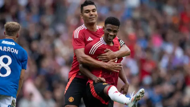 Amad Diallo celebrates scoring against Rangers with Casemiro