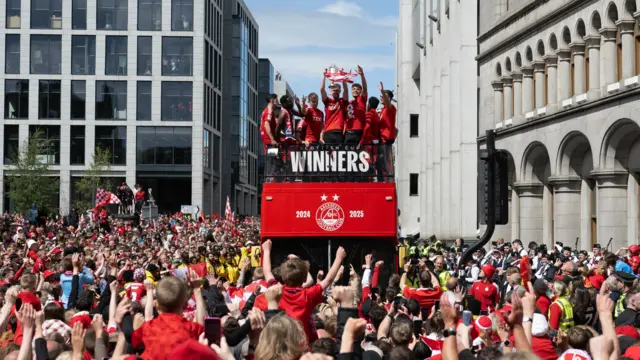 Aberdeen's Alfe Dorrington is pictured leading the celebrations during the Aberdeen bus parade to celebrate winning the Scottish Gas Scottish Cup