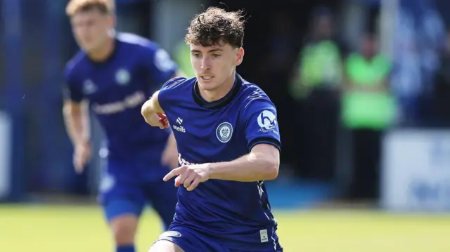 Liam Humbles in action for Rochdale wearing a blue playing shirt