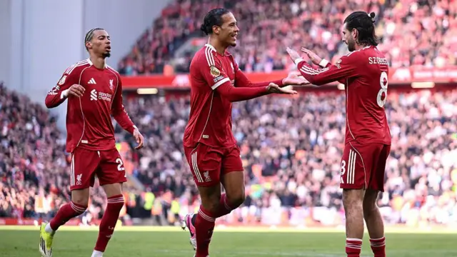 Virgil van Dijk of Liverpool celebrates scoring his team's second goal with teammate Dominik Szoboszlai.