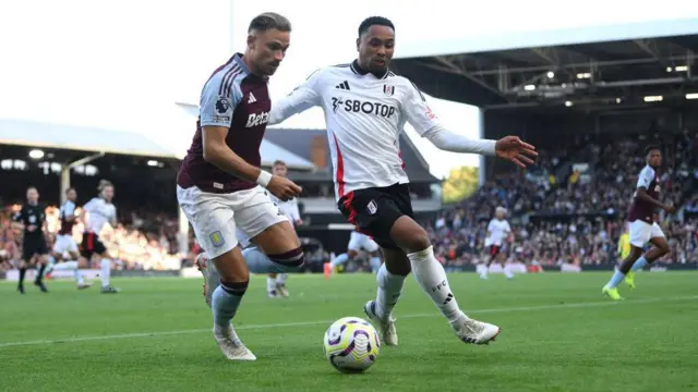 Matty Cash and Kenny Tete compete for the ball