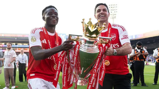 Bukayo Saka and Mikel Arteta of Arsenal lift the Premier League Trophy
