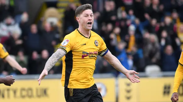 Newport County centre-back James Clarke celebrates scoring a goal