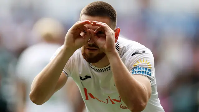 Zan Vipotnik of Swansea City celebrates with his hands making goggles
