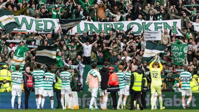 Celtic players applaud the home fans
