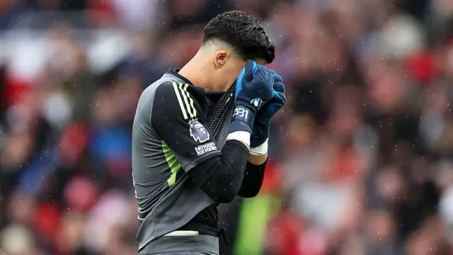 Altay Bayindir reacts with his shirt over his face