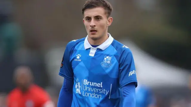 Jack Wells-Morrison in a blue Wealdstone shirt with blue undershirt.