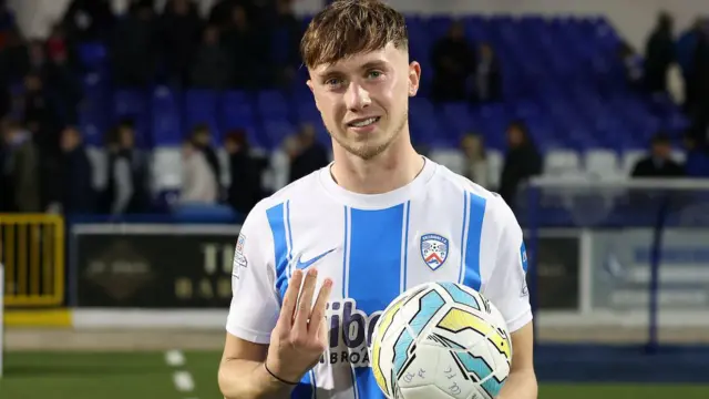 Matthew Shevlin celebrates with the match ball