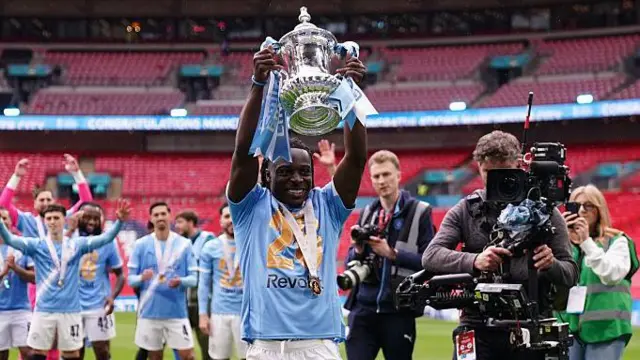 Jeremy Doku of Manchester City celebrates with supporters