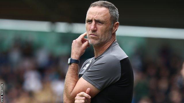 Andy Crosby looks on the pitch during a match