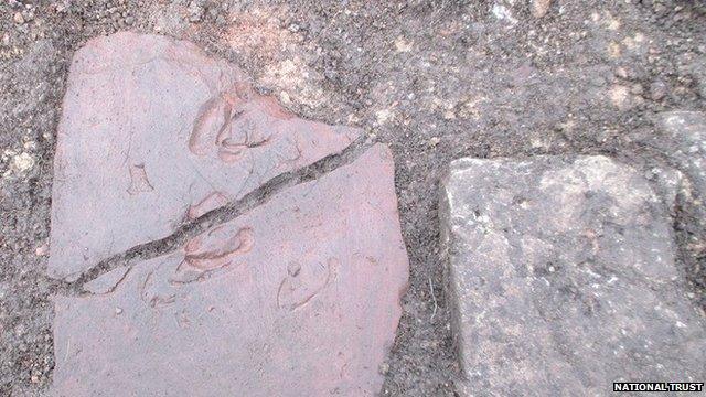 Tile with animal footprint