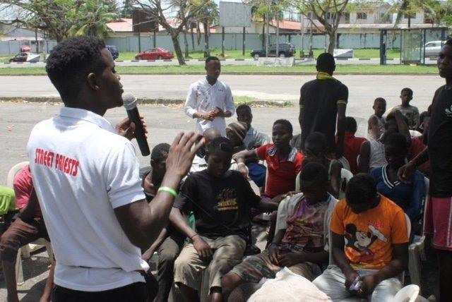 Okina speaking to volunteers