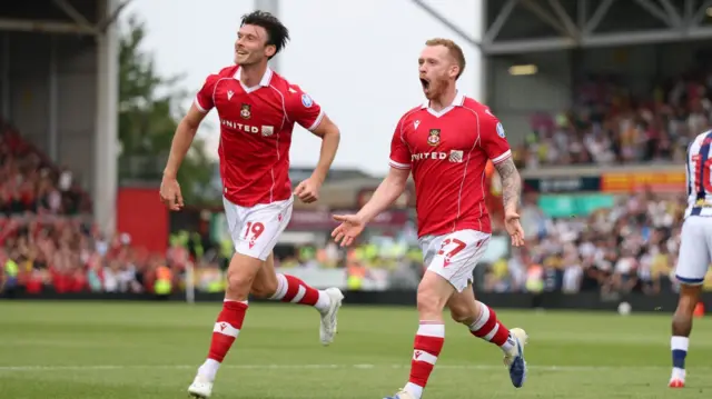 Wrexham midfielder Lewis O'Brien (R) celebrates with team-mate Kieffer Moore