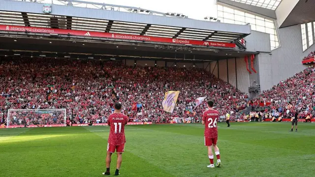 Mohamed Salah and Andy Robertson being saluted by the Kop at Anfield