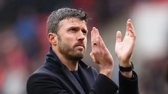 Michael Carrick, Manchester United boss, acknowledges the fans.