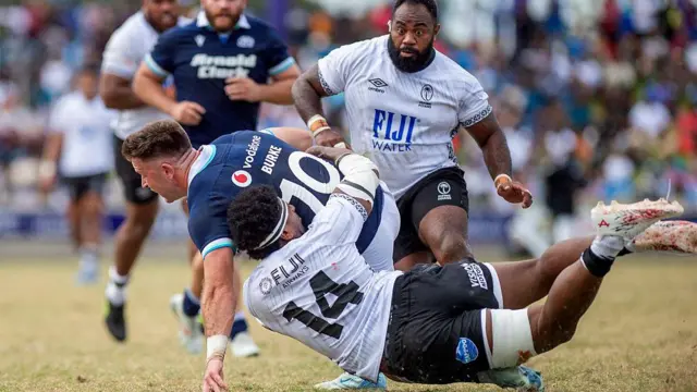 Fiji's Kalaveti Ravouvou (R) tackles Scotland's Fergus Burke during the rugby test match between Fiji and Scotland at HFC Bank Stadium in Suva