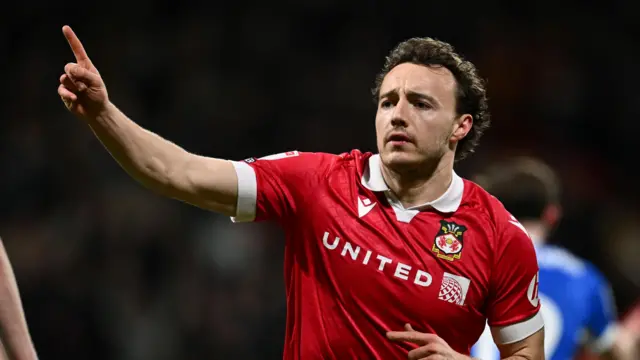 Ollie Rathbone celebrates scoring a goal for Wrexham