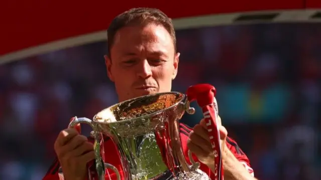 Jonny Evans lifts the FA Cup trophy