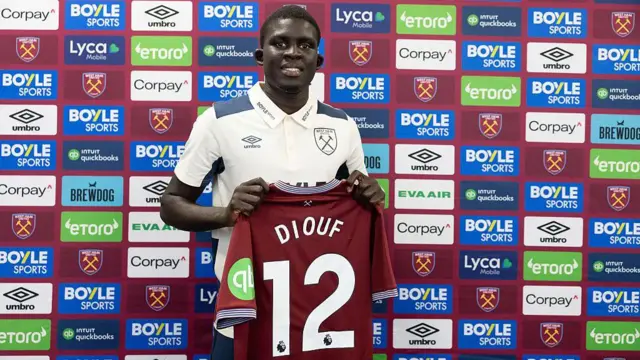 El Hadji Malick Diouf holding a West Ham home shirt