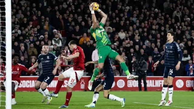 Aston Villa's goalkeeper Emiliano Martinez cuts out a cross 