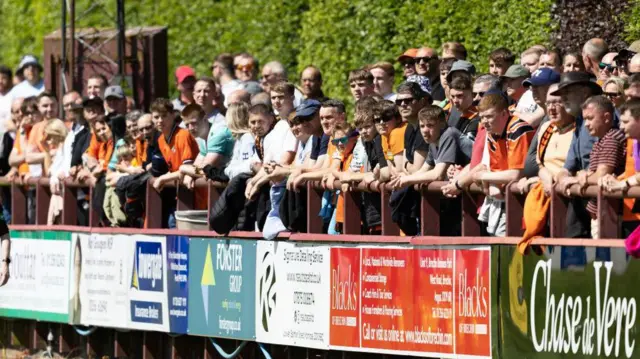 Fans line Glebe Park's hedge