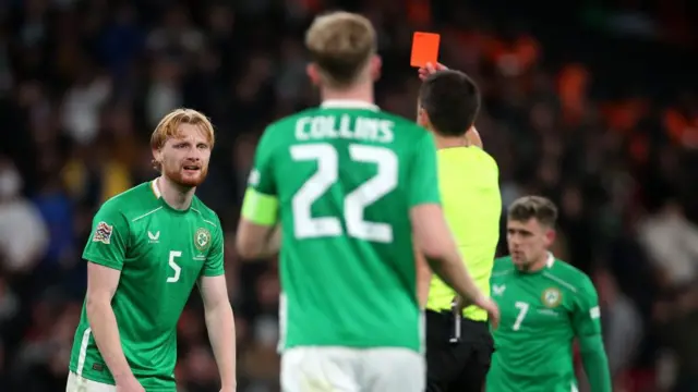 Liam Scales of Republic of Ireland is shown a red card by Referee Erik Lambrechts during the UEFA Nations League 2024-25 League B Group B2 match between England and Republic of Ireland at Wembley Stadium