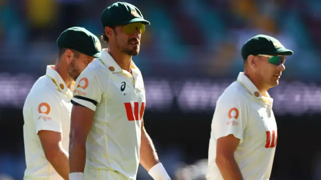 Australia's Mitchell Starc and Scott Boland walk off the field