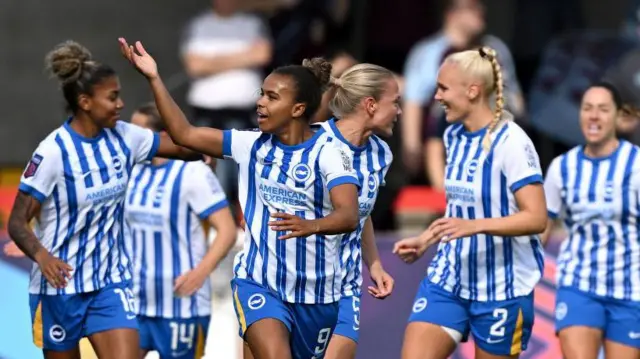 Nikita Parris celebrates her goal v Everton as teammates run to join her