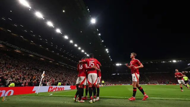 Manchester United players celebrate scoring 