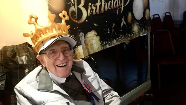 George Forster wearing a birthday crown at his birthday celebration