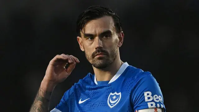 Marlon Pack, wearing the blue Portsmouth shirt, looks serious during a recent game