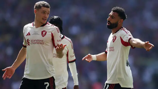 Mohamed Salah of Liverpool speaks with Florian Wirtz of Liverpool during the 2025 FA Community Shield match between Crystal Palace and Liverpool at Wembley Stadium