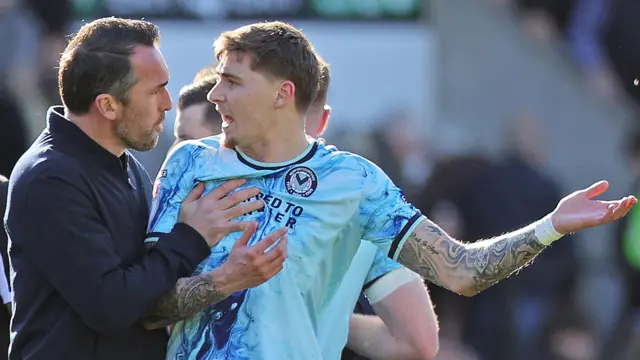 Christian Fuchs talks to James Crole after Newport's defeat by Notts County