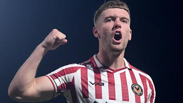 Cameron Evans celebrates after Newport County's penalty shoot-out win at Barnet