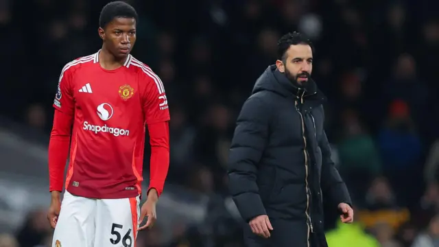 Chido Obi in action for Manchester United with Ruben Amorim standing behind on the touchline
