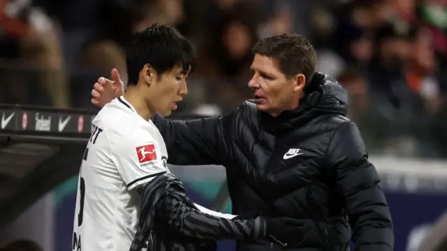 Oliver Glasner, Head Coach of Eintracht Frankfurt, speaks with their player Daichi Kamada during the Bundesliga match between Eintracht Frankfurt and VfL Bochum 1848 at Deutsche Bank Park on March 31, 2023