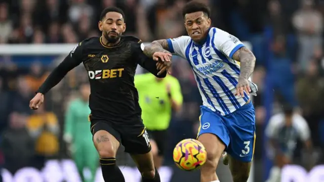 Matheus Cunha of Wolverhampton Wanderers is challenged by Igor of Brighton & Hove Albion during the Premier League match between Brighton & Hove Albion FC and Wolverhampton Wanderers FC at Amex Stadium on October 26, 2024