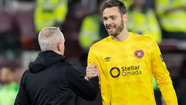 Hearts head coach Neil Critchley (L) shakes hands with Hearts' Craig Gordon