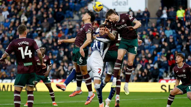 Cameron Burgess and Marko Stamenic compete for a header at West Brom 