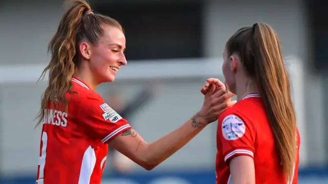 Caitlin McGuinness is congratulated after scoring Cliftonville's first goal against Glentoran