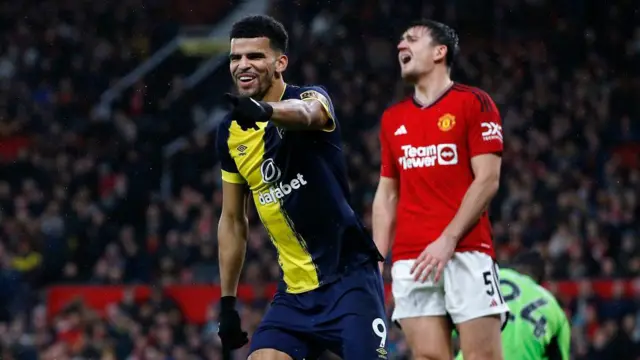 Dominic Solanke celebrates, Harry Maguire can be seen in the background