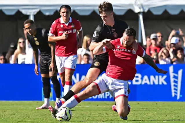 Alex Scott battles for the ball with Jack Marriott of Wrexham