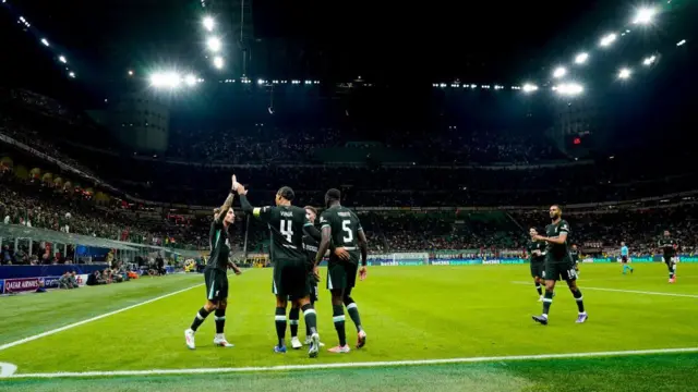 Liverpool players celebrate against AC Milan