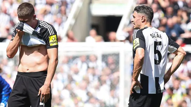Sven Botman and Fabian Schar look dejected after defeat