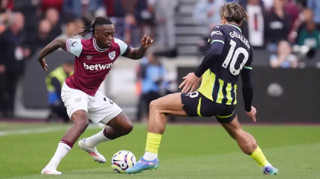 Aaron Wan-Bissaka takes on Jack Grealish