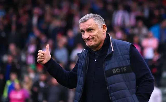 Tony Mowbray with his thumbs up in his Boss gilet