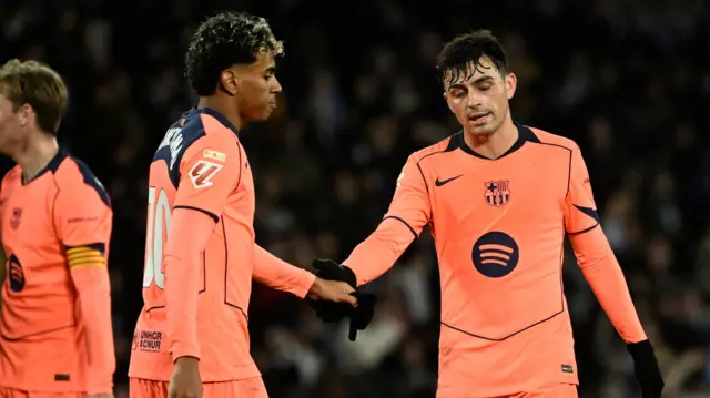 Lamine Yamal and Pedri shake hands with each other while playing for Barcelona