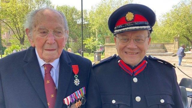 Richard Jedynakiewicz, wearing medals, and his son Nicholas